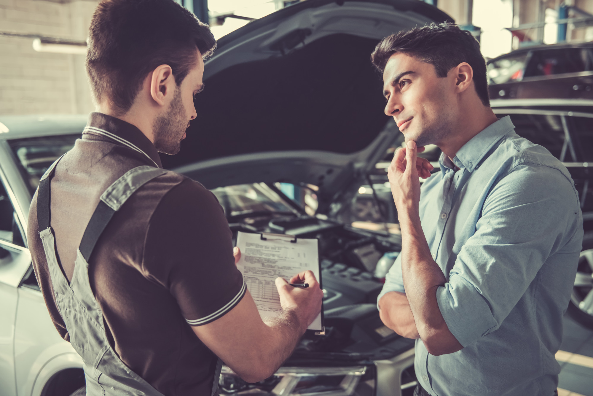 person talking to auto mechanic