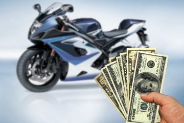 Motorcycle and person holding money