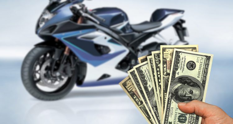 Motorcycle and person holding money