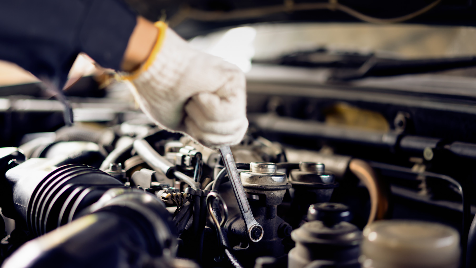 person performing DIY car maintenance