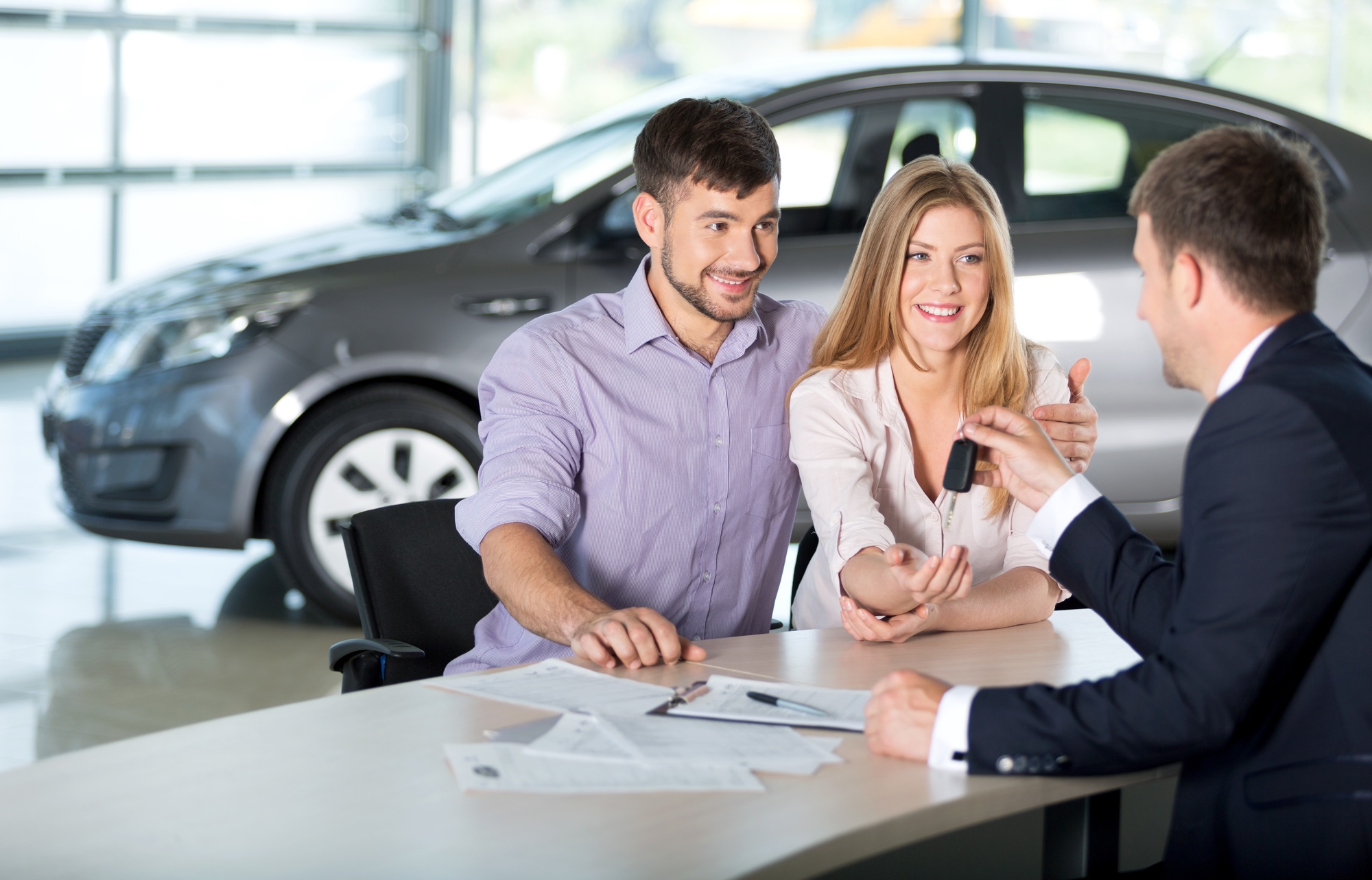 couple buying car from dealership