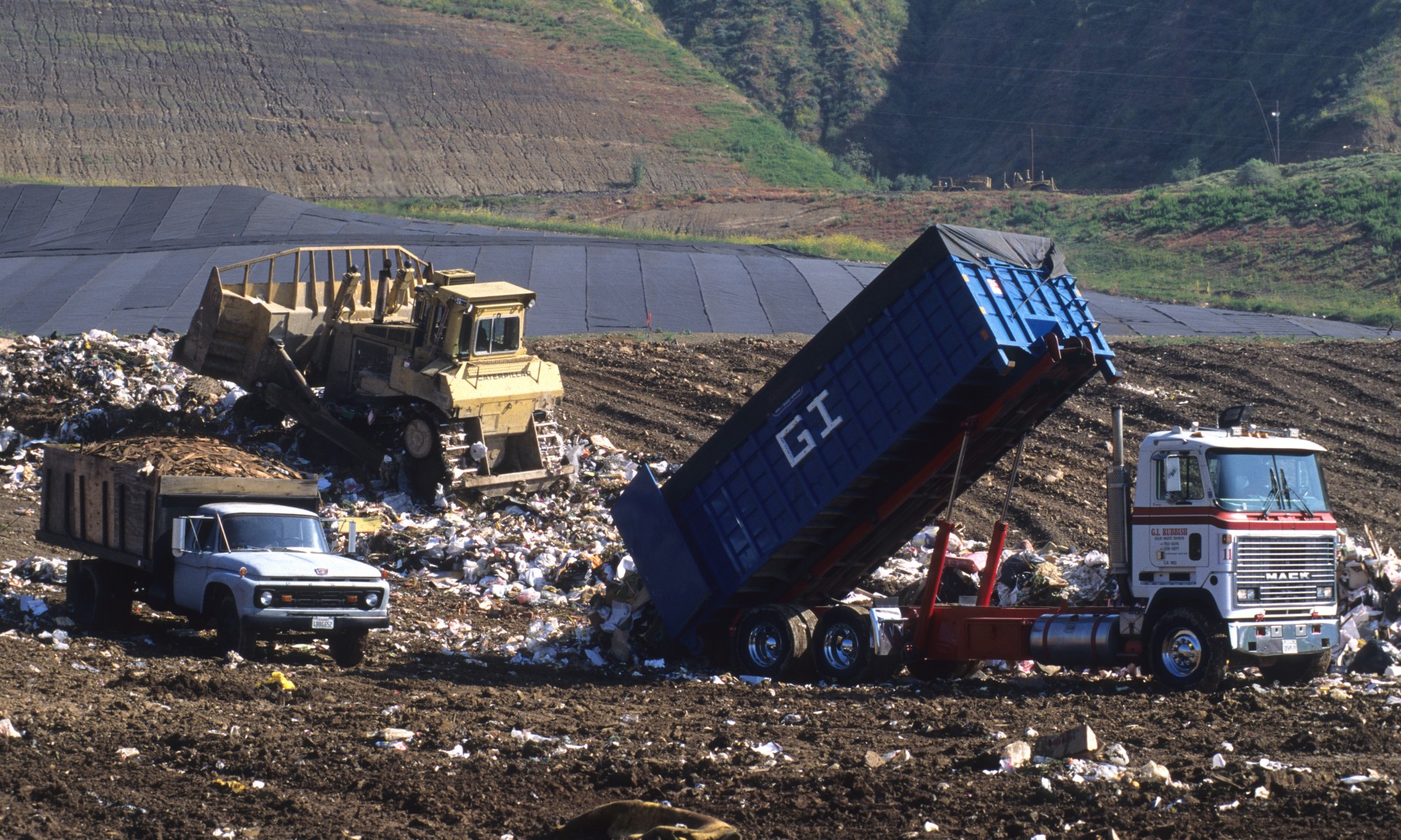 garbage trucks at dump