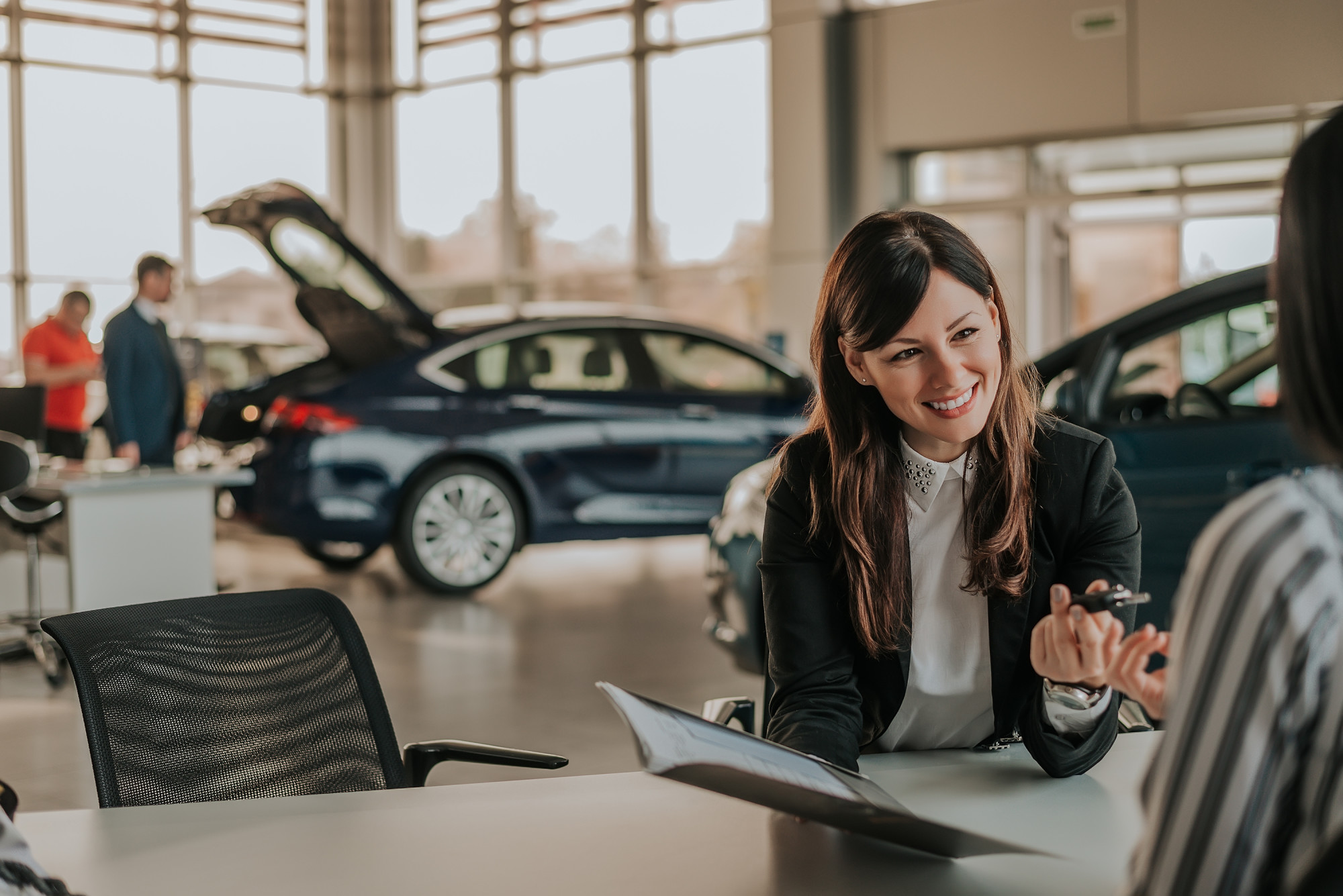 woman buying car at dealership