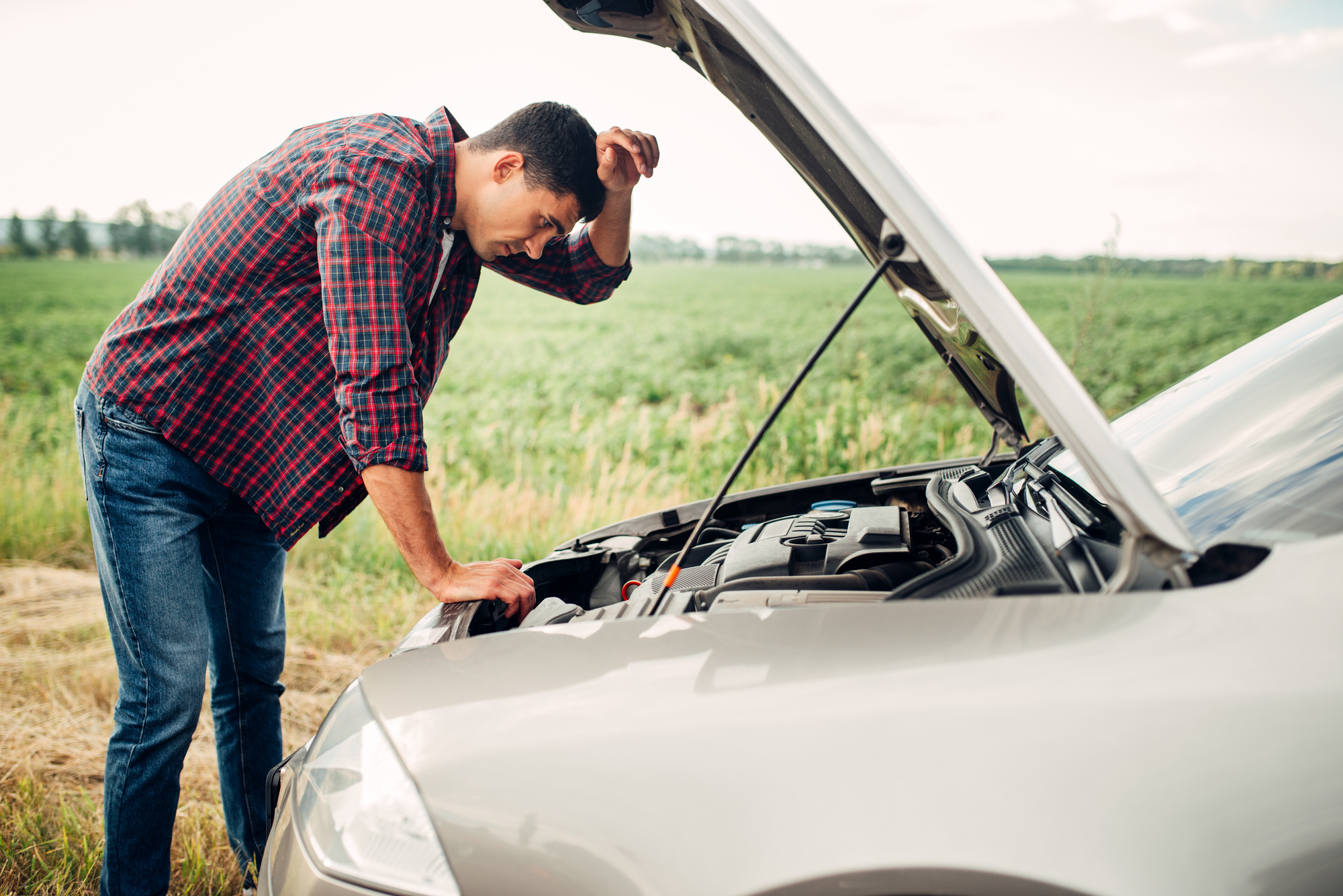 broken down car with frustrated man