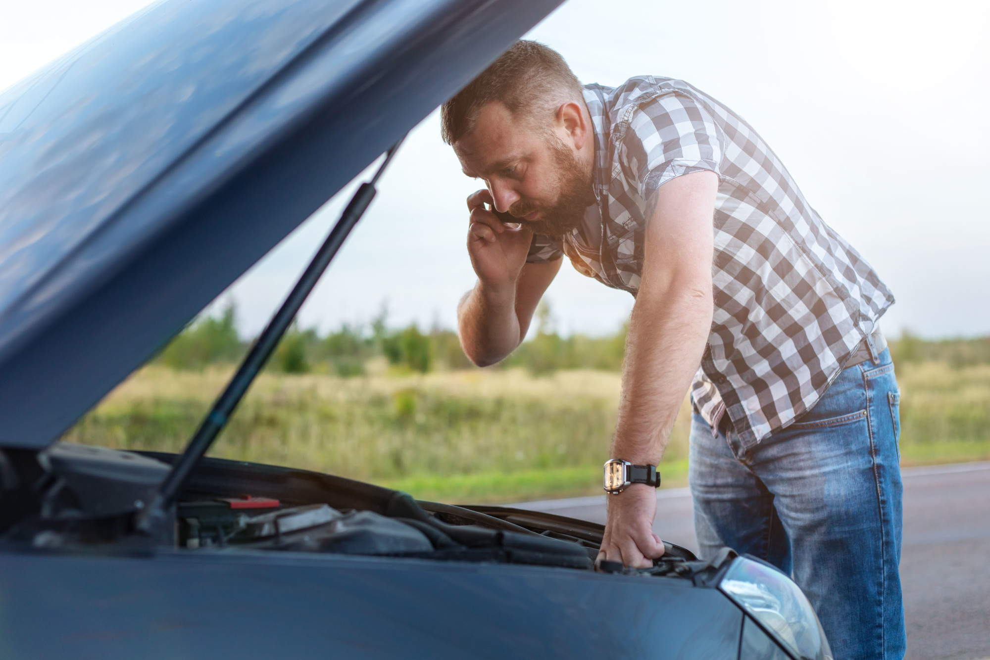 Man with Broken Car on a Road